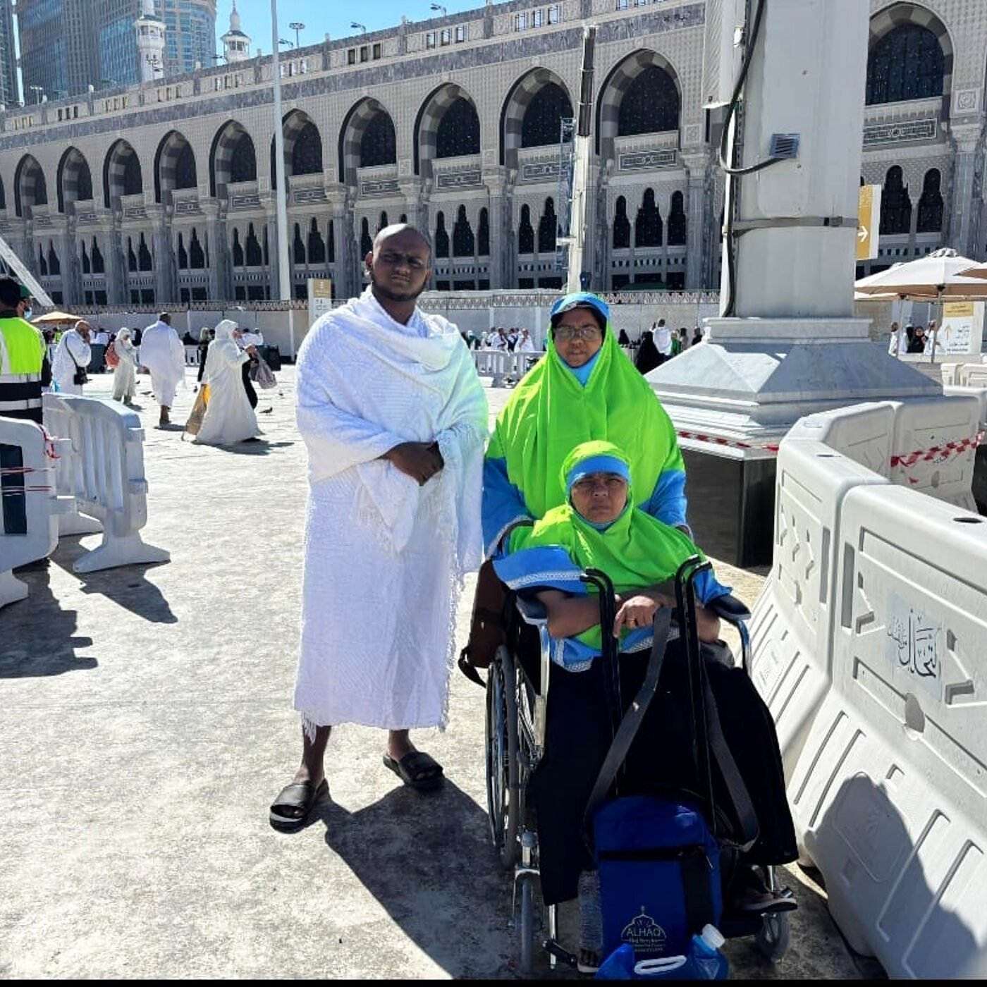 Pilgrim receiving wheelchair assistance